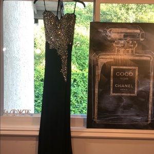 Beautiful floor length black dress, with leg slit.